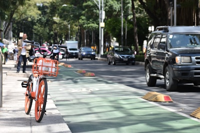 red bicycle on road during daytime