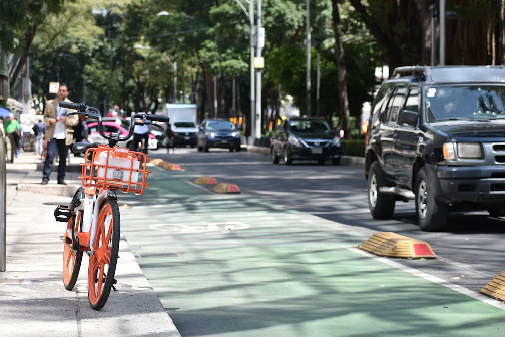 red bicycle on road during daytime