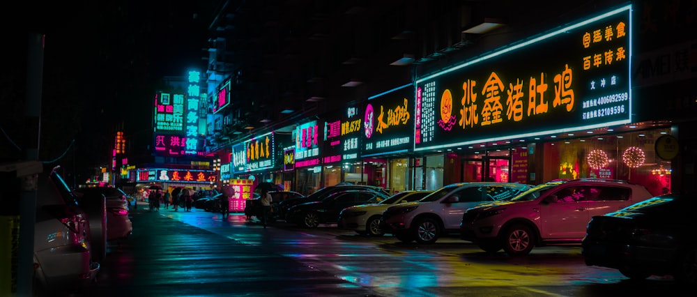 cars on road near buildings during night time