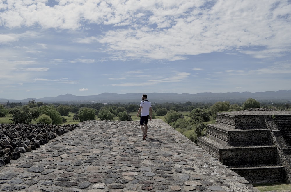 woman in black shirt and black shorts standing on gray concrete stairs during daytime