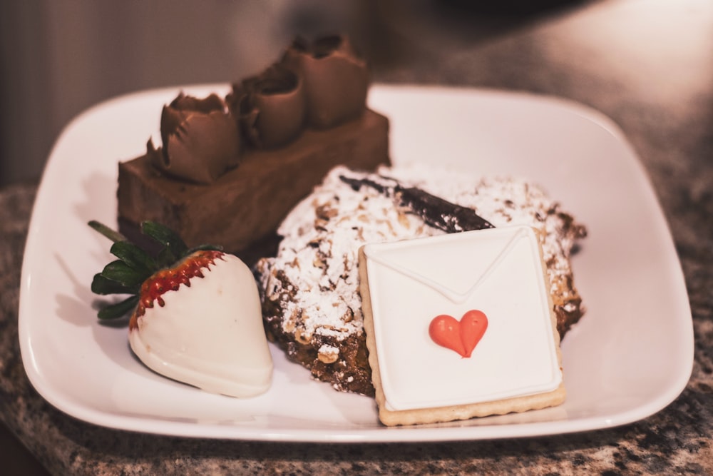 chocolate cake with cherry on white ceramic plate