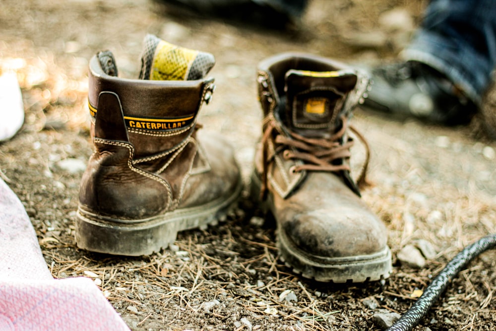 person wearing brown leather work boots