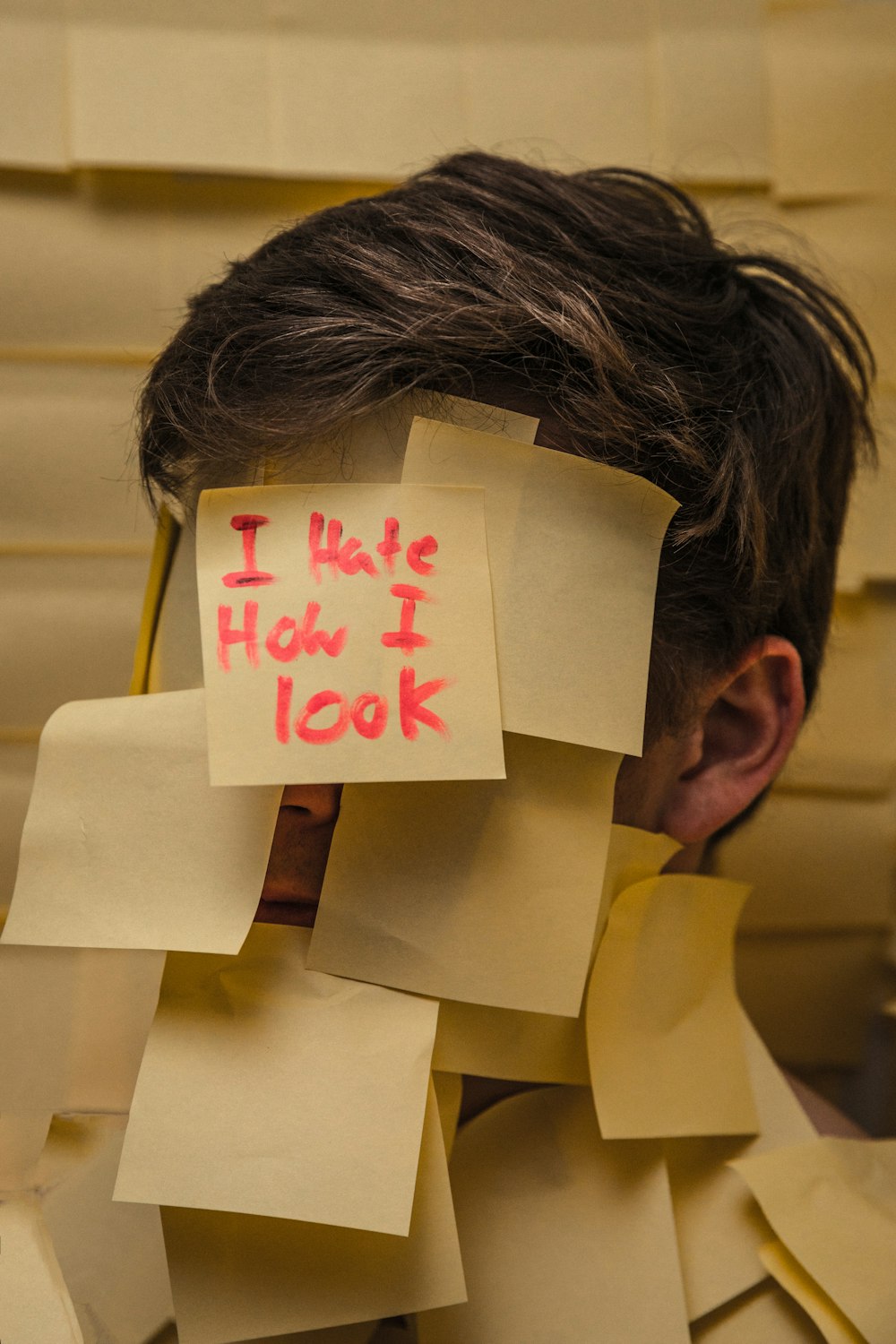 person in yellow shirt with white printer paper