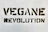 Bold black stencil text reading 'VEGANE REVOLUTION' is spray-painted on a textured white wall.