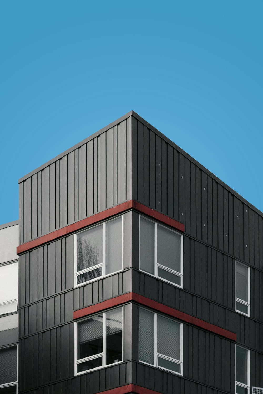 white and red concrete building under blue sky during daytime