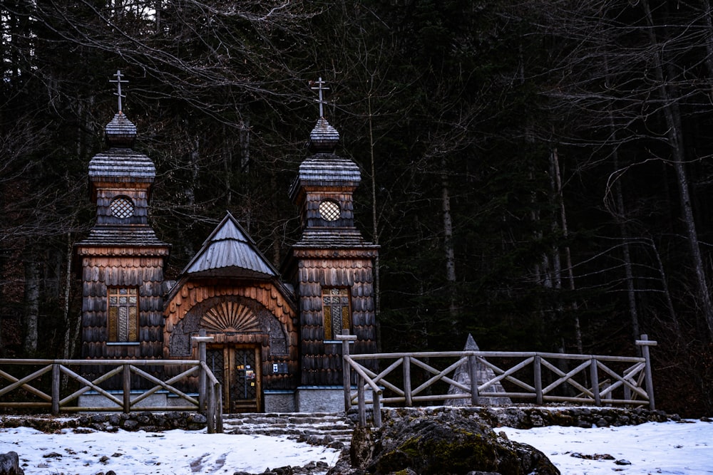 brown wooden house in the middle of the forest