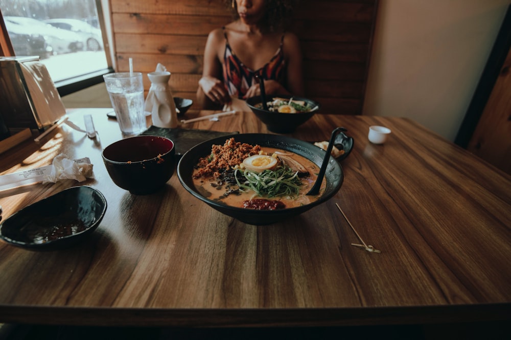 woman in black tank top sitting beside woman in white tank top