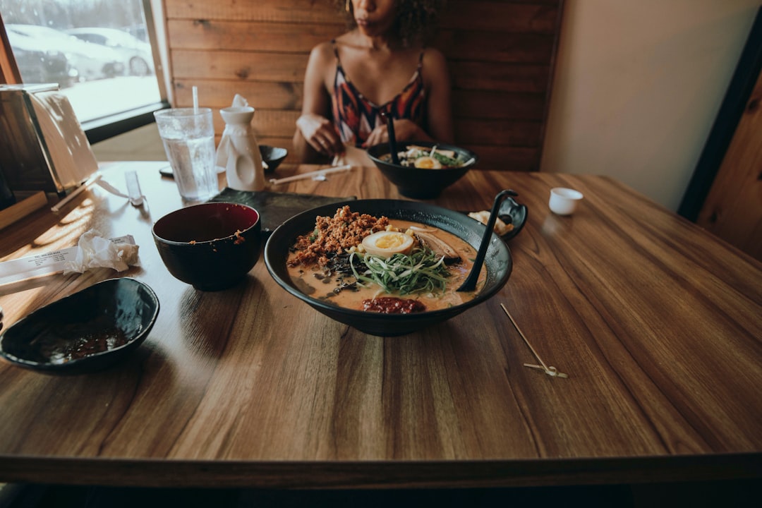 woman in black tank top sitting beside woman in white tank top