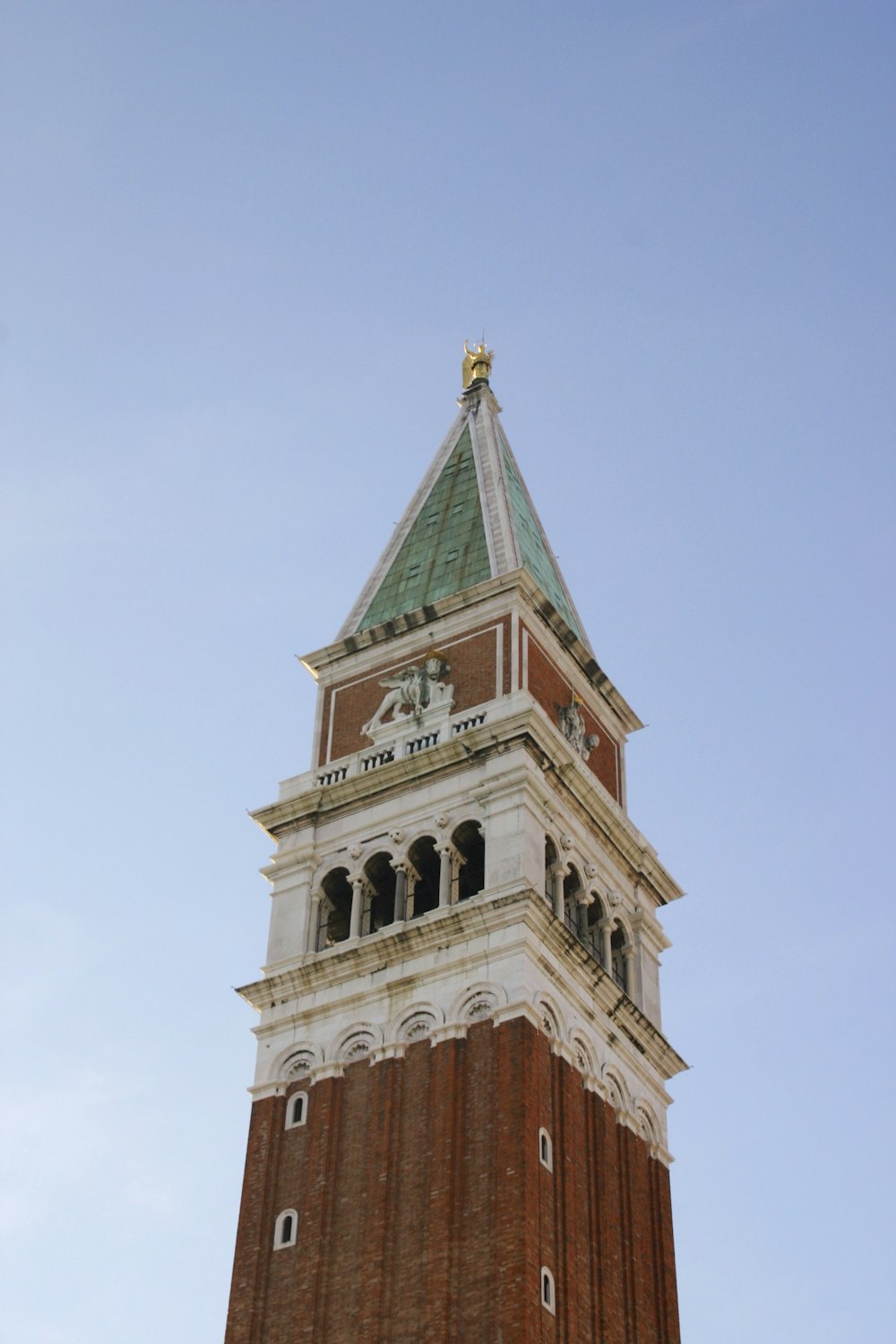 brown and green concrete building under blue sky during daytime