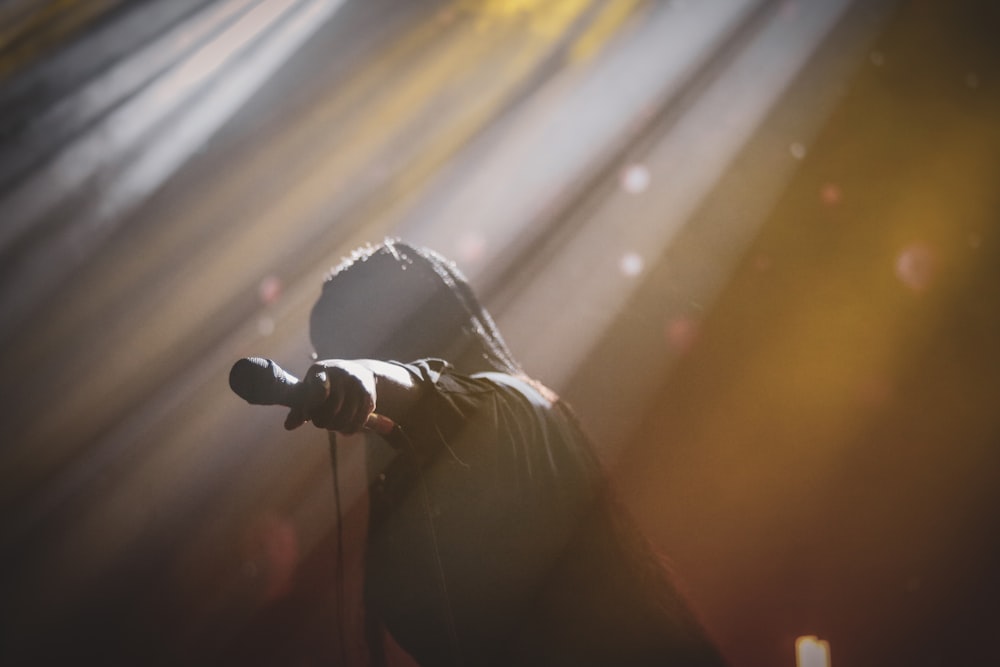 man in black jacket singing