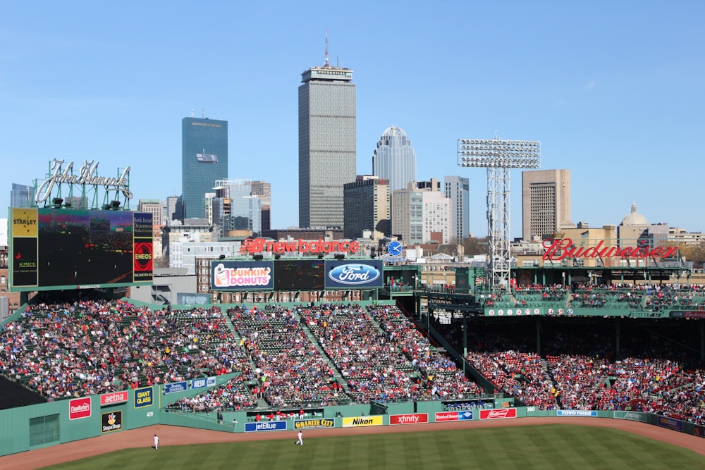 people watching baseball game during daytime