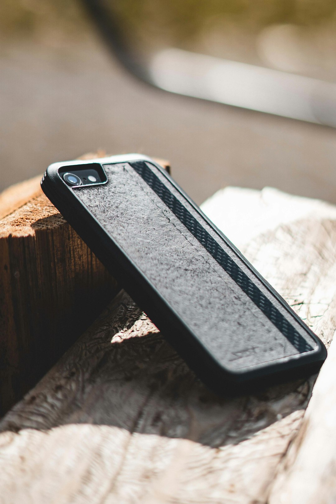black iphone case on brown wooden table