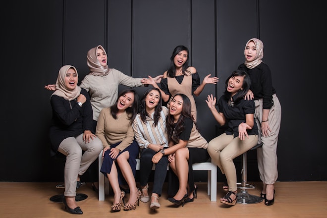 group of women sitting on black couch