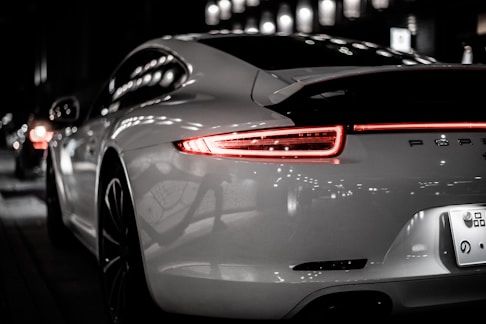 silver porsche 911 parked on parking lot