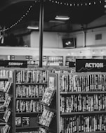 grayscale photo of books on shelves