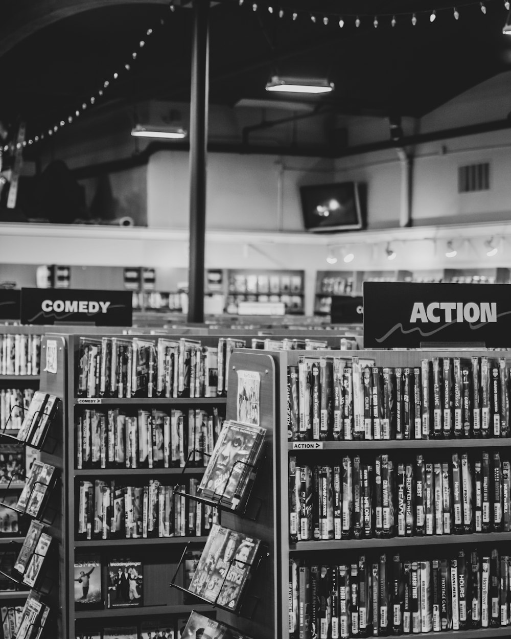 grayscale photo of books on shelves