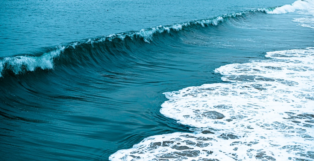 white and black rock formation on body of water during daytime