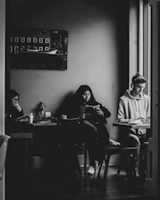man in gray hoodie sitting on chair