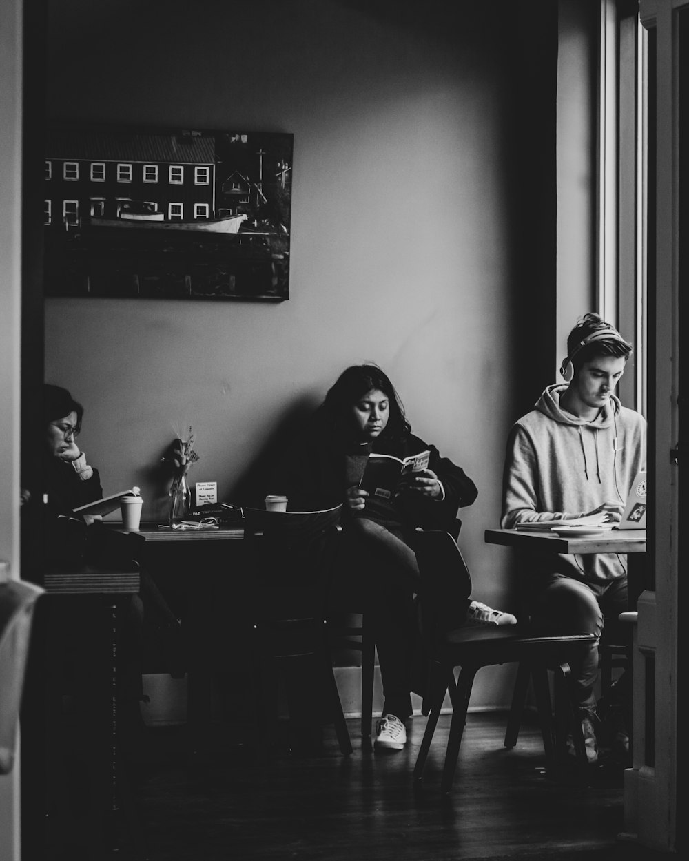 man in gray hoodie sitting on chair