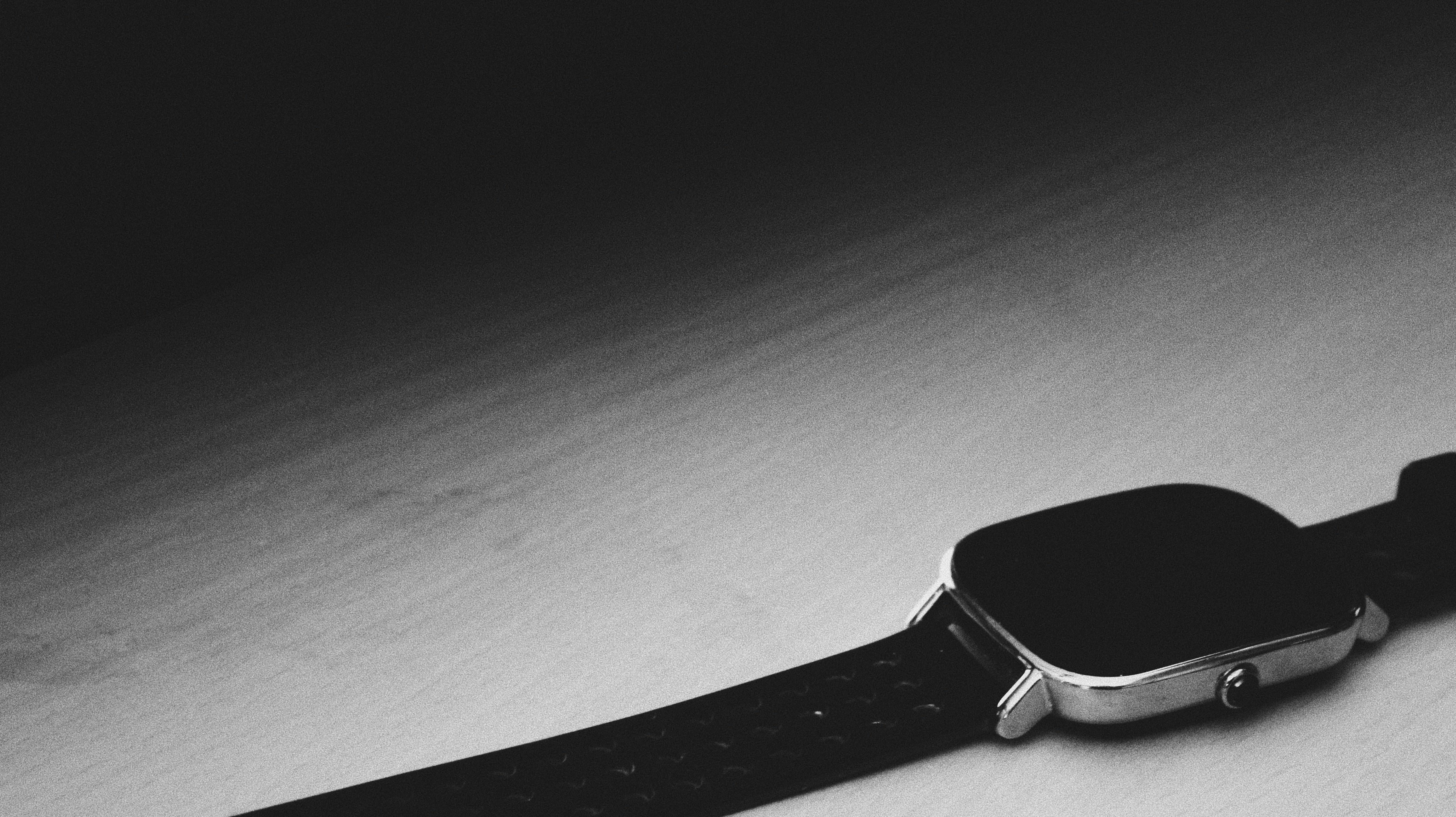 Premium smartwatch with stainless steel case on wooden surface