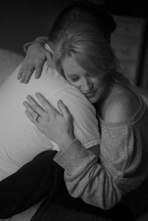 woman in gray sweater lying on bed