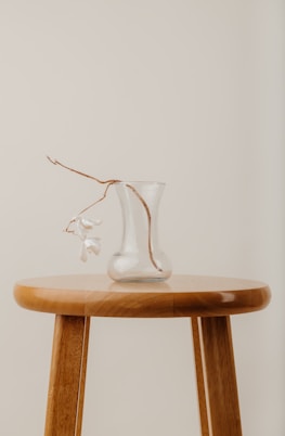 clear glass vase on brown wooden table