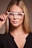 woman in black shirt wearing white framed eyeglasses