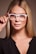 woman in black shirt wearing white framed eyeglasses