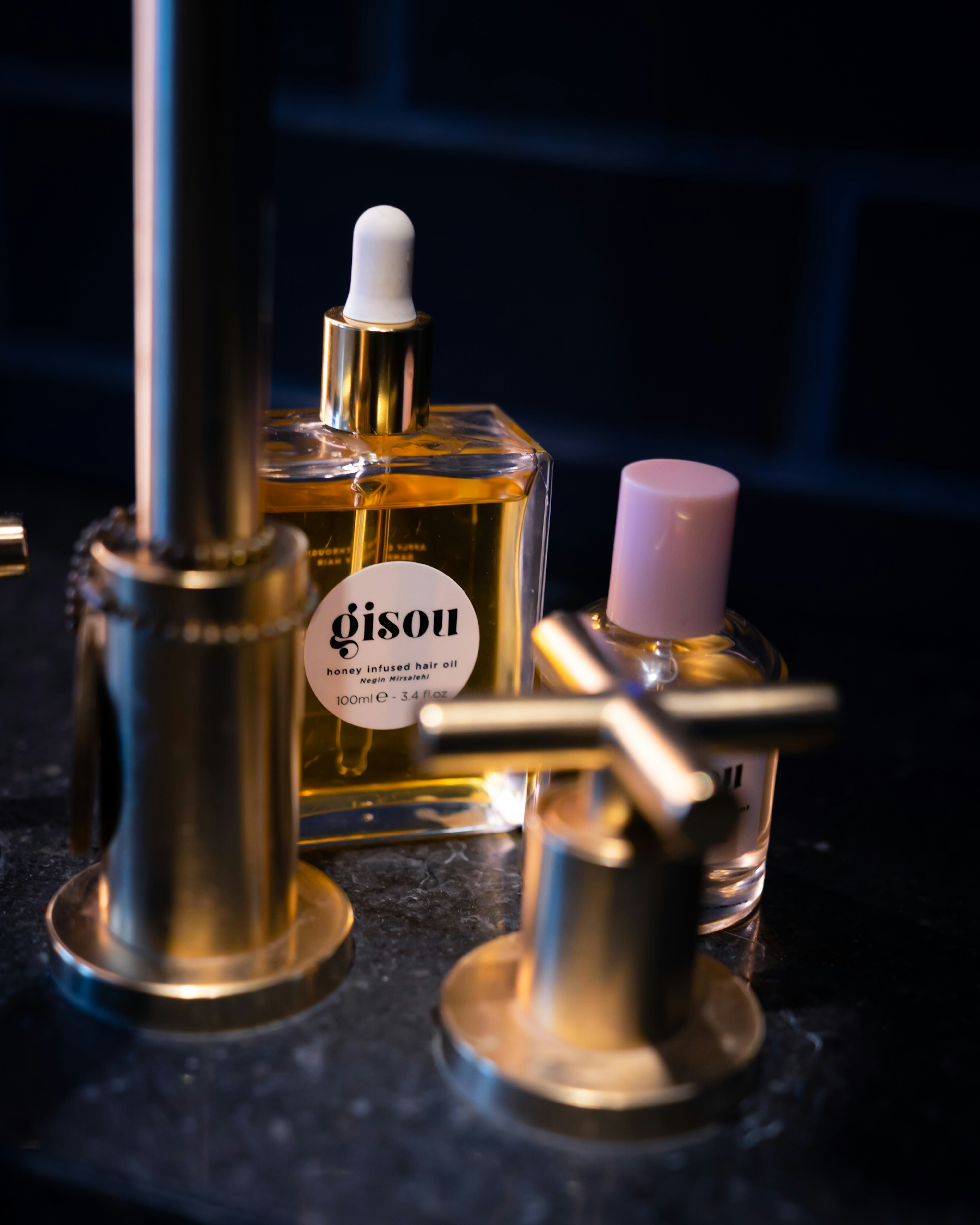 Two perfume bottles on a black table
