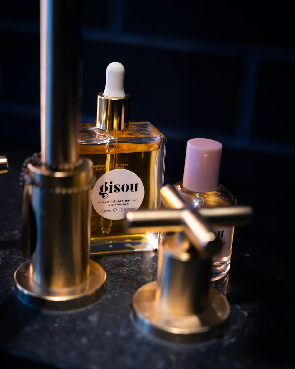 two perfume bottles on black table