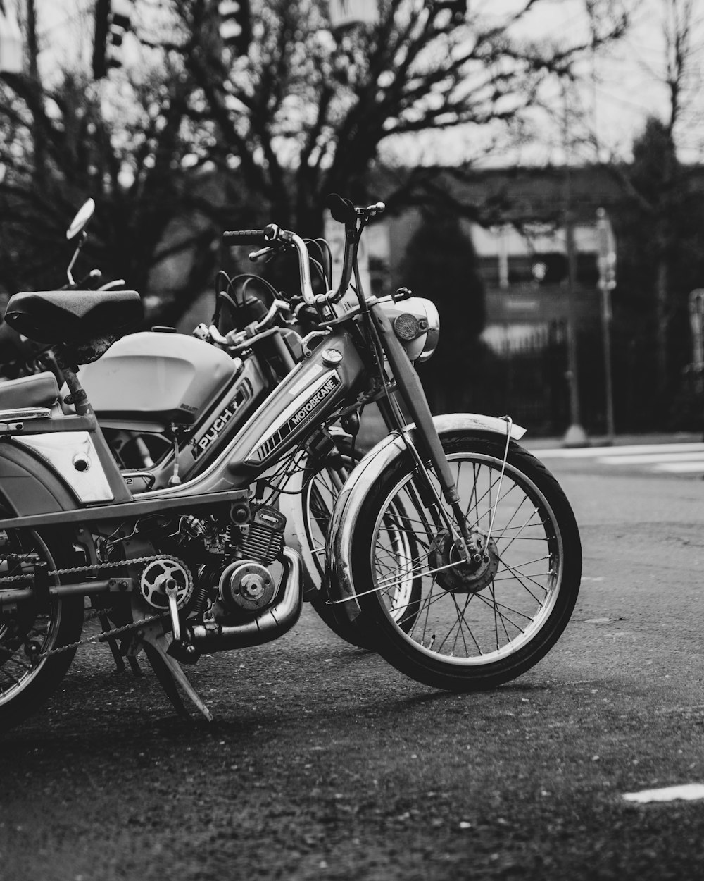 black and gray motorcycle parked on gray concrete road during daytime