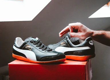 A pair of worn shoes being replaced with new sneakers handed over with a smile.