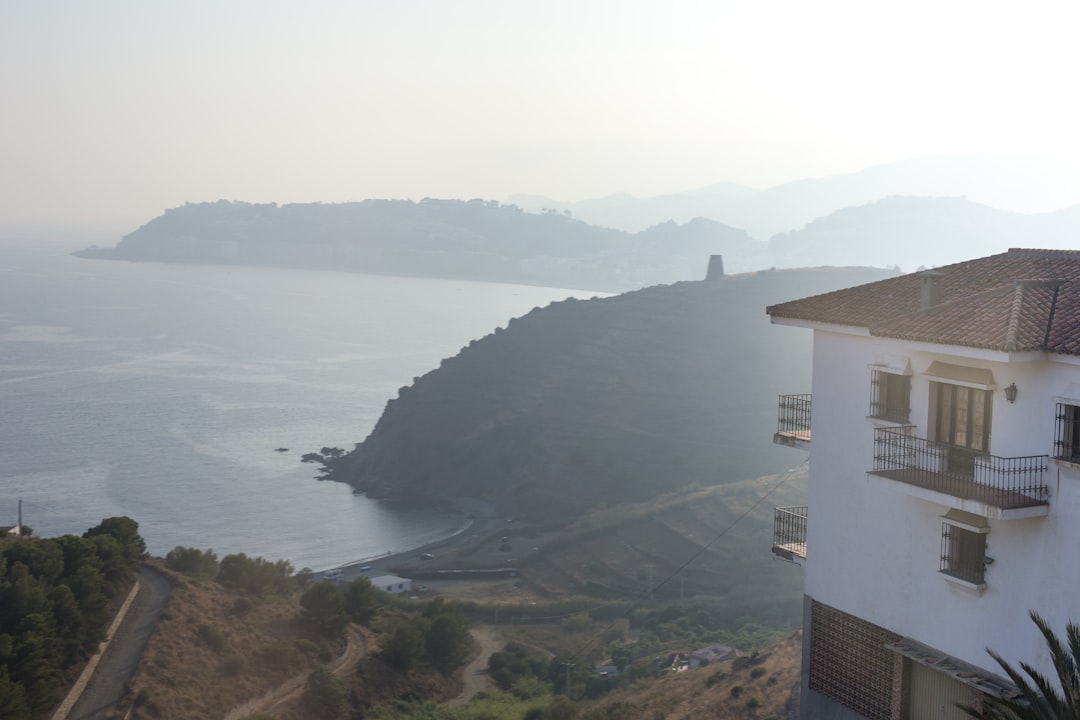 white concrete building near body of water during daytime