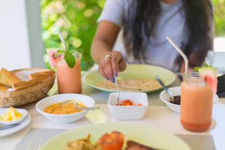 person holding silver fork and knife slicing a vegetable on white ceramic plate