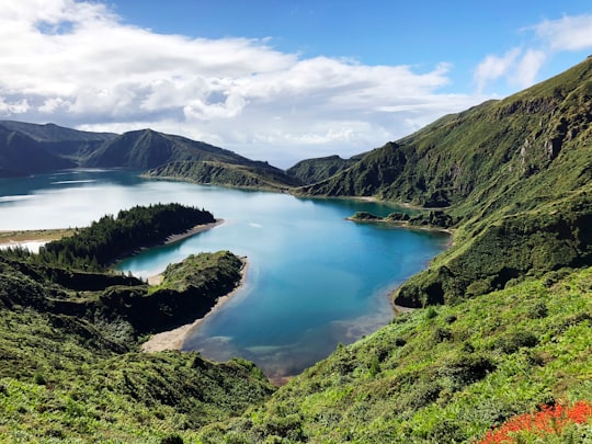 lake in the middle of mountains during daytime in Lagoa do Fogo Portugal