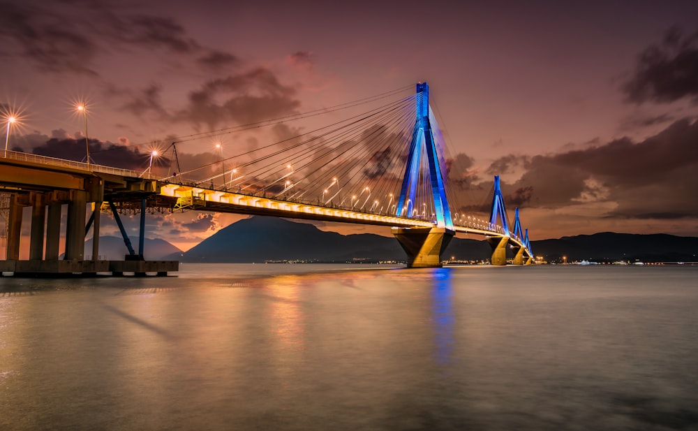 bridge over water under cloudy sky during daytime