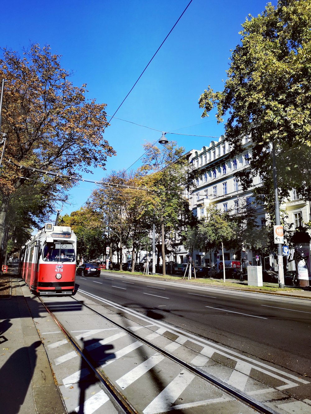 red and white tram on road during daytime