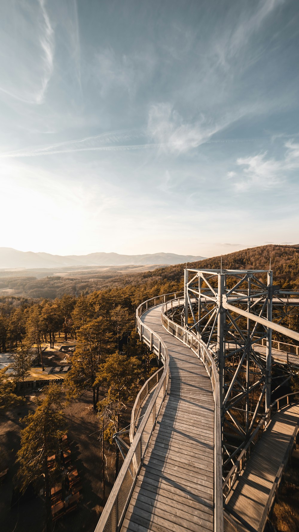 gray wooden bridge over the mountains during daytime