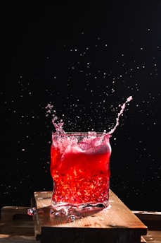 red liquid in clear drinking glass