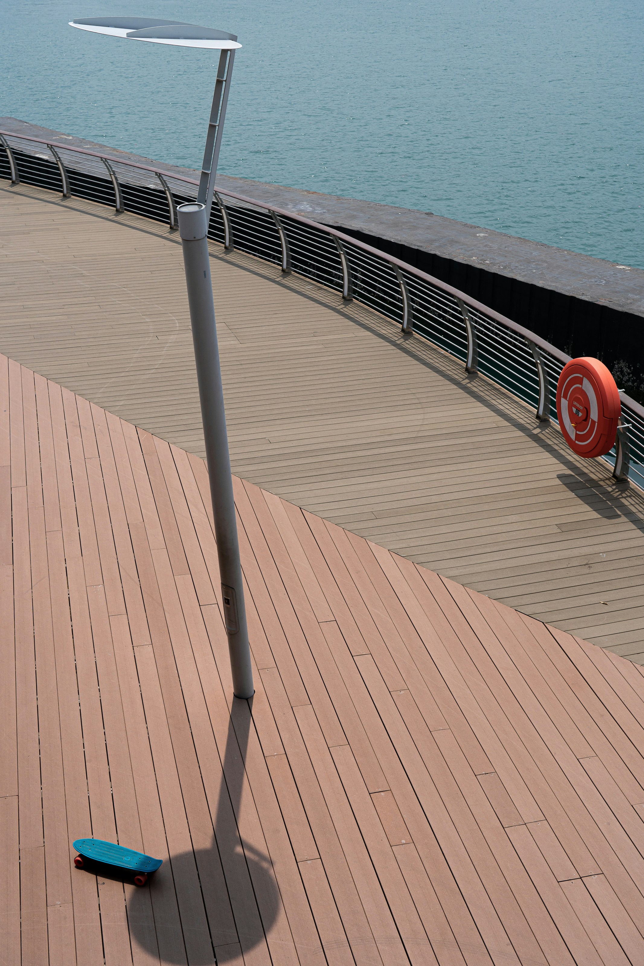 red car on road near sea during daytime