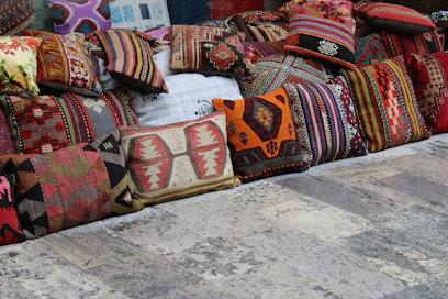 Close-up of colorful home decor items including vases and cushions in a cozy living room setting.