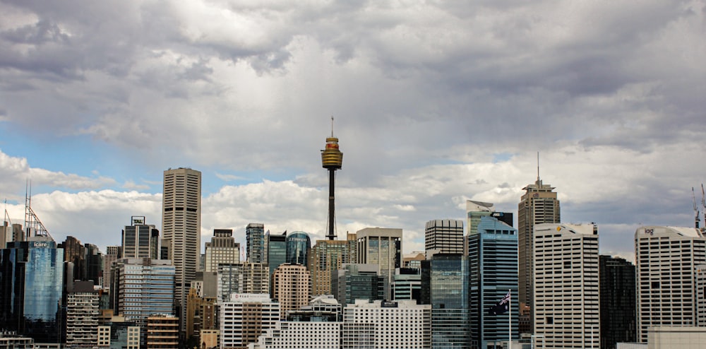 high rise buildings under white clouds during daytime