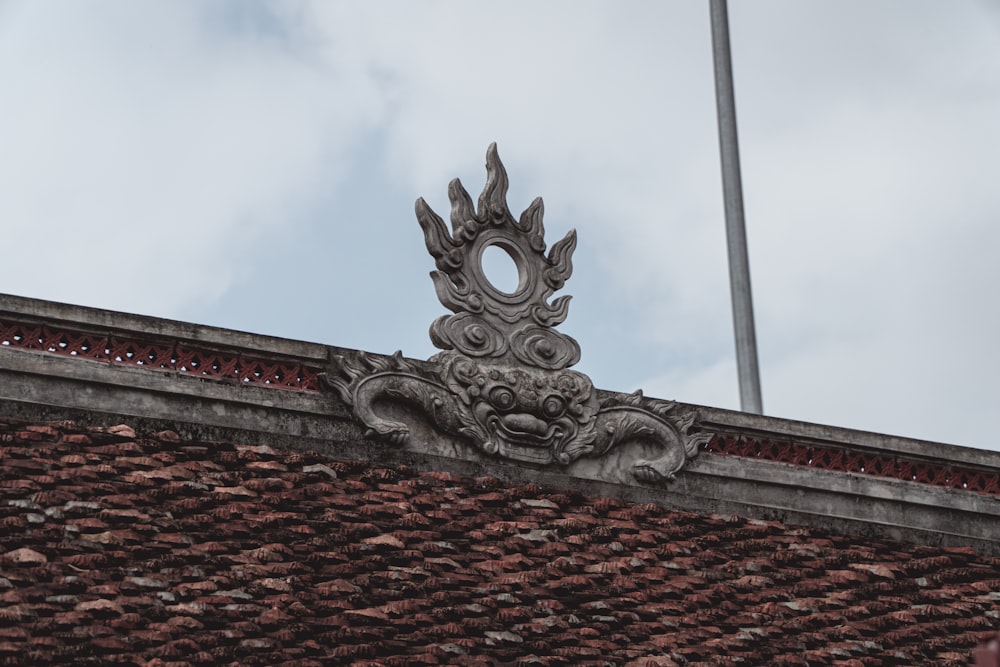 grey dragon statue on roof