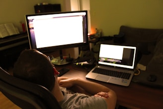 Close-up of Sasha Cvetko analyzing data on multiple sleek screens in a minimalist, high-contrast office.