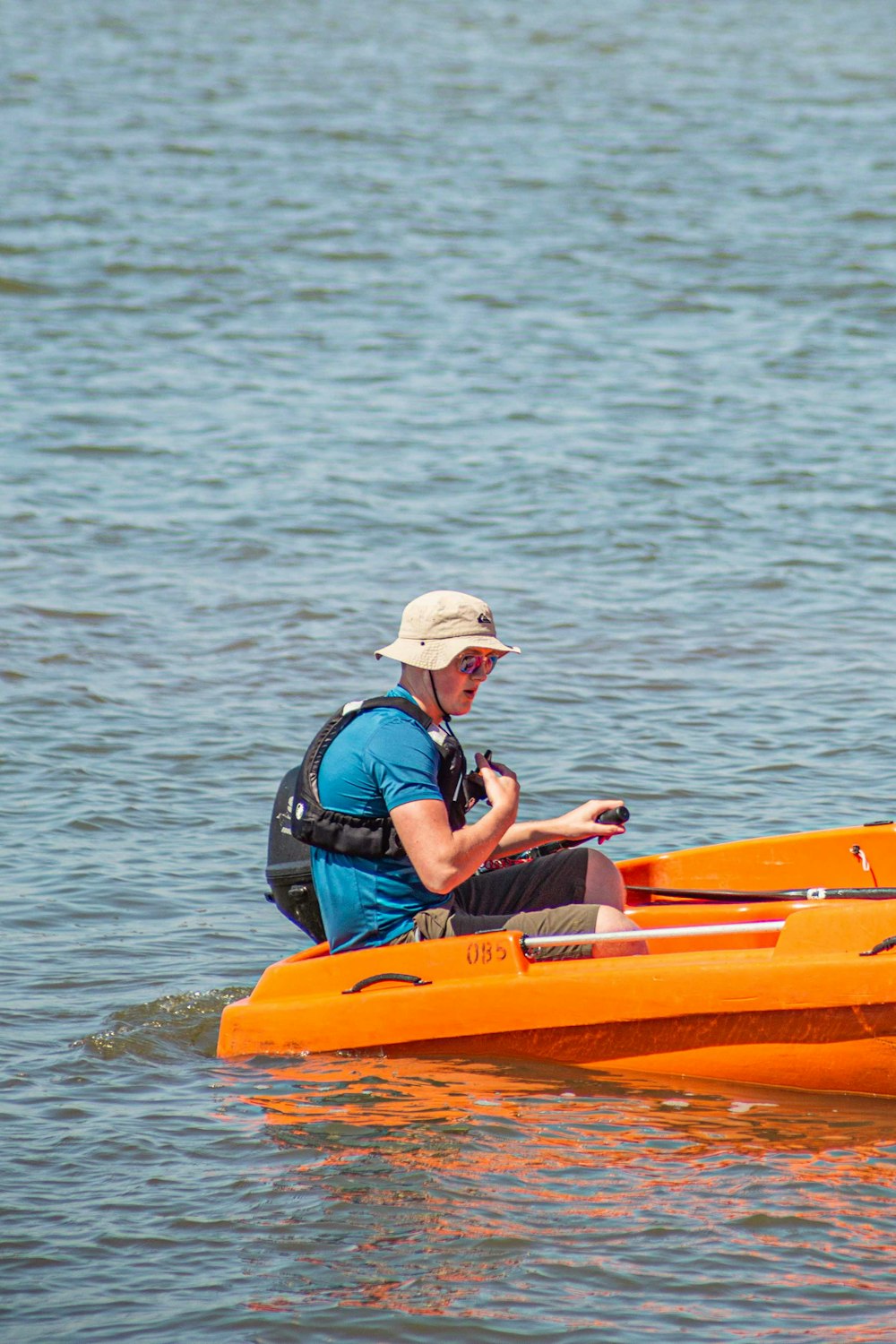 uomo in giacca nera e rossa che cavalca kayak giallo sul mare durante il giorno
