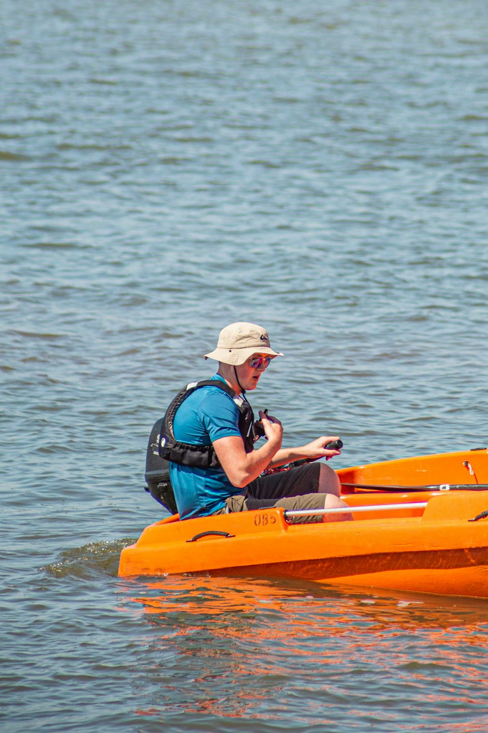 man in black and red jacket riding yellow kayak on sea during daytime