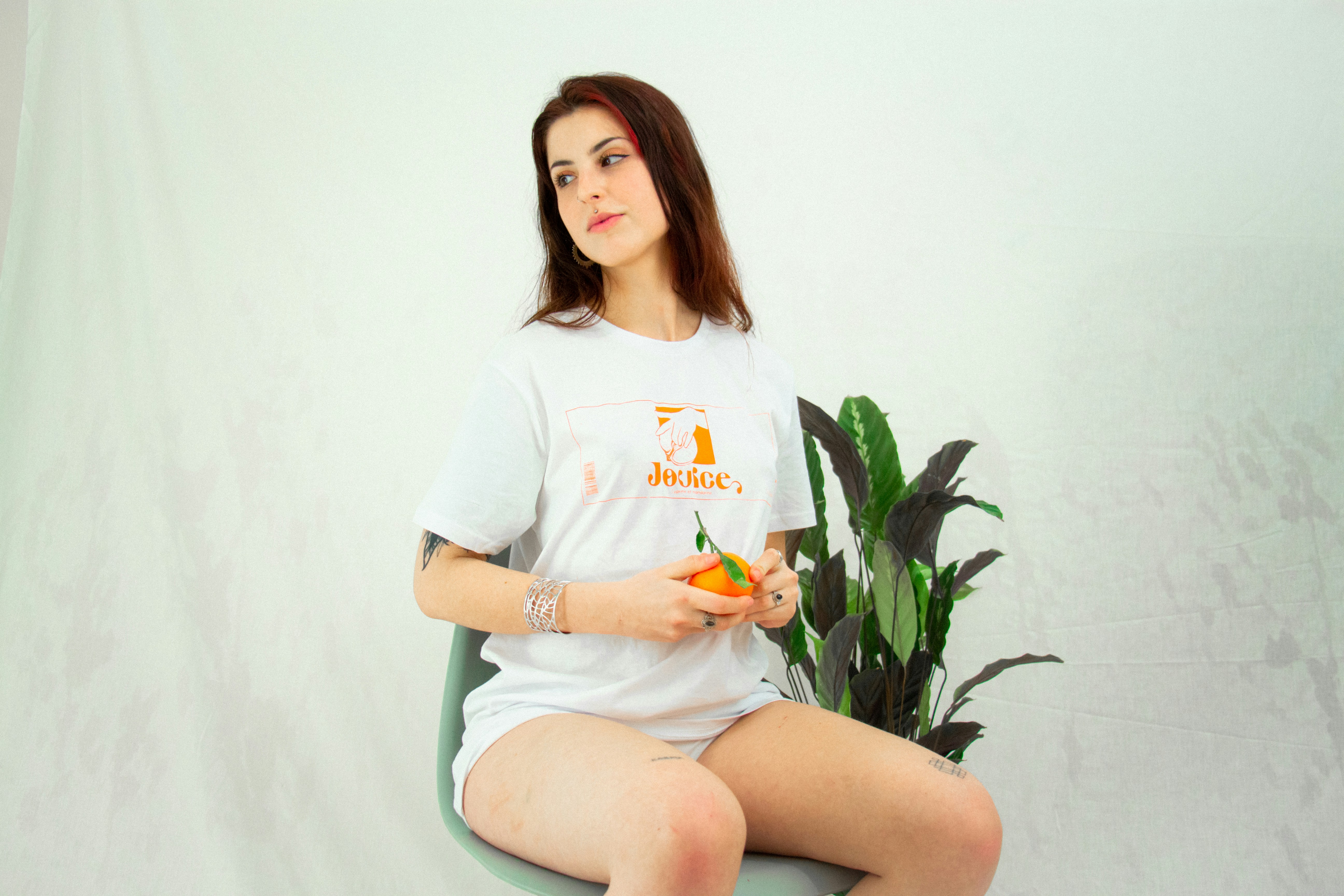 woman in white crew neck t-shirt sitting on white chair