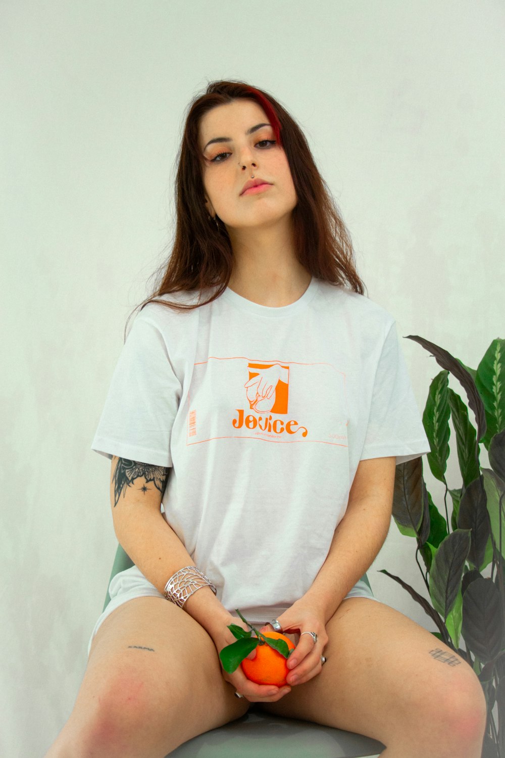 woman in white crew neck t-shirt sitting on white bed