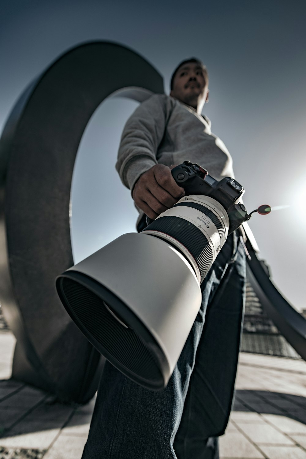 man in black jacket holding black and white camera