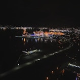 Night view of a completed maritime facility illuminated by work lights.